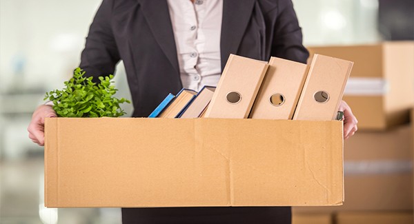 Picture of a person holding a box with random objects in it.