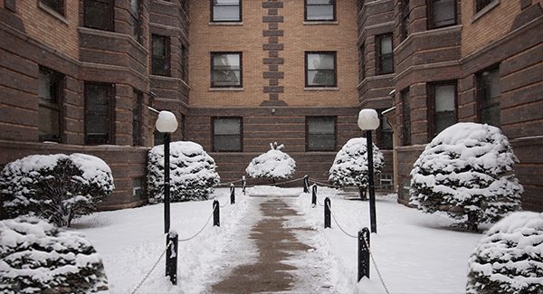 Picture of a snowy walkway up to a building.