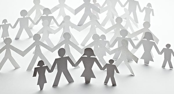 Picture of paper people holding hands representing family.