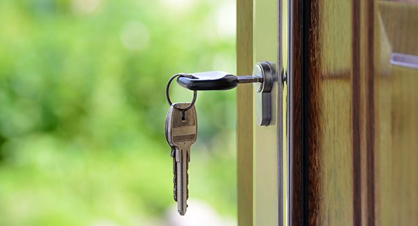 Picture of keys unlocking a front door.