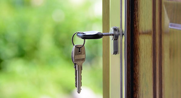 Picture of keys unlocking a front door.