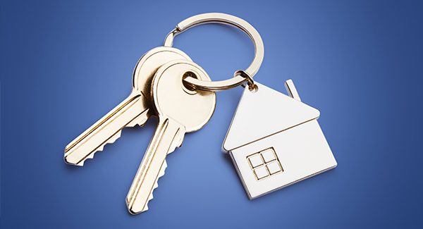 House on keychain representing property.