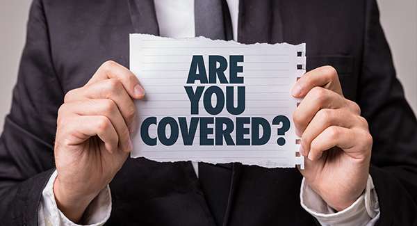 Picture of person holding sign saying Are you Covered?