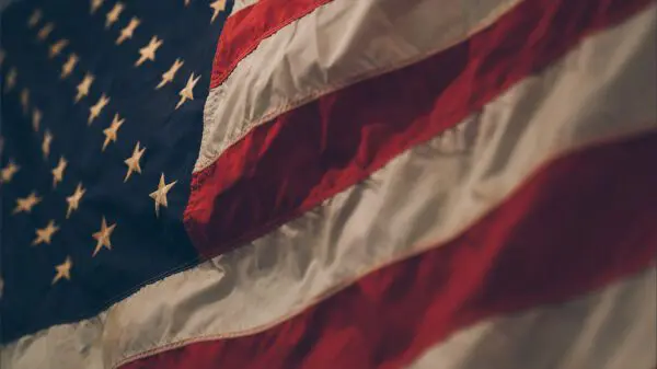 Close-up of a portion of the United States flag showing stars on a blue field and red and white stripes.