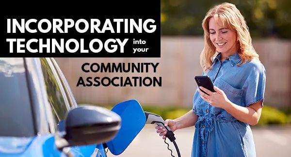Woman charging electric car while looking happily at her cell phone