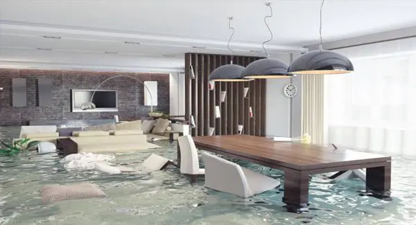 A modern living and dining room is flooded with water, with furniture partially submerged and floating.