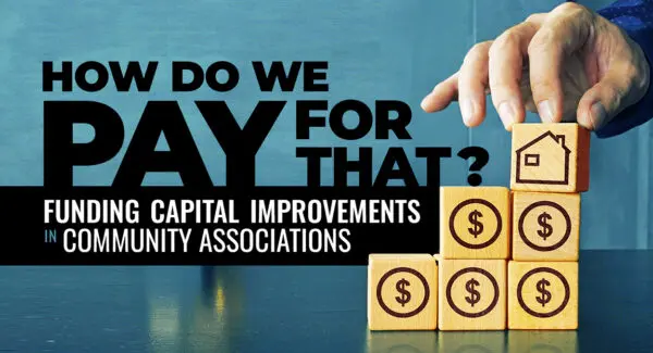 A hand stacks wooden blocks with dollar signs and a house icon; text reads, "How do we pay for that? Funding capital improvements in community associations.