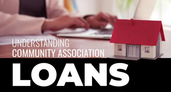 A person types on a laptop next to a small model house; text reads "Understanding Community Association Loans.