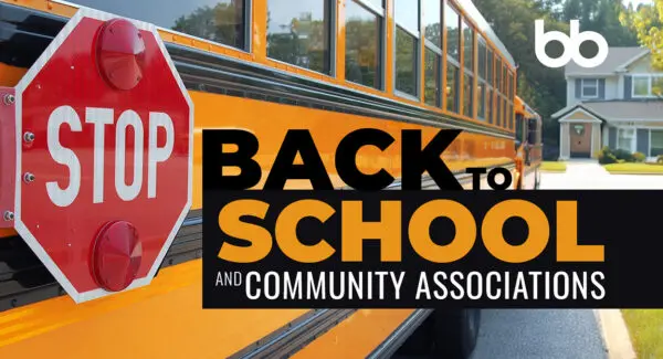 Yellow school bus with stop sign extended; text reads "Back to School and Community Associations" with suburban houses visible in the background.