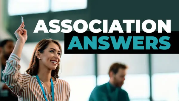 A woman holds up a pen while seated in a meeting room, with the words "Association Answers" displayed in large text above her.