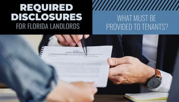 Two people review and discuss a document about required disclosures for Florida landlords; one person points at the paper with a pen.