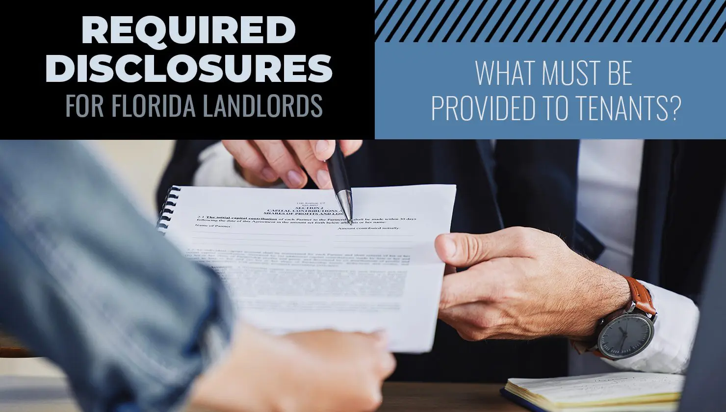 Two people review and discuss a document about required disclosures for Florida landlords; one person points at the paper with a pen.