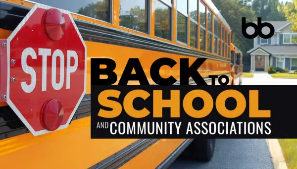 A school bus with a stop sign is parked by a suburban street; text reads “Back to School and Community Associations.”.