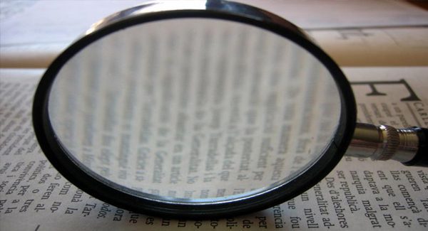 magnifying glass on a book.